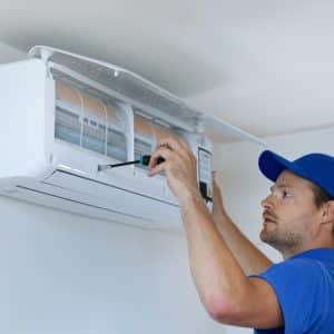 man replacing air conditioner